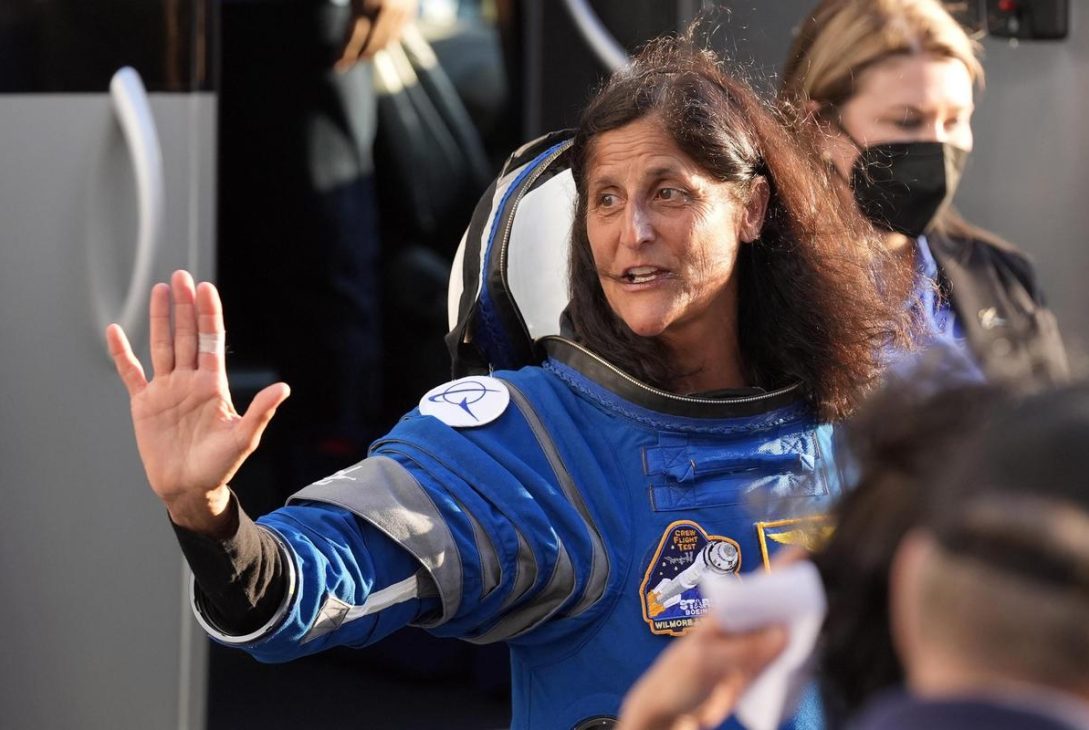 Sunita Williams, a female astronaut, floats in the ISS with a joyful expression, mid-dance.